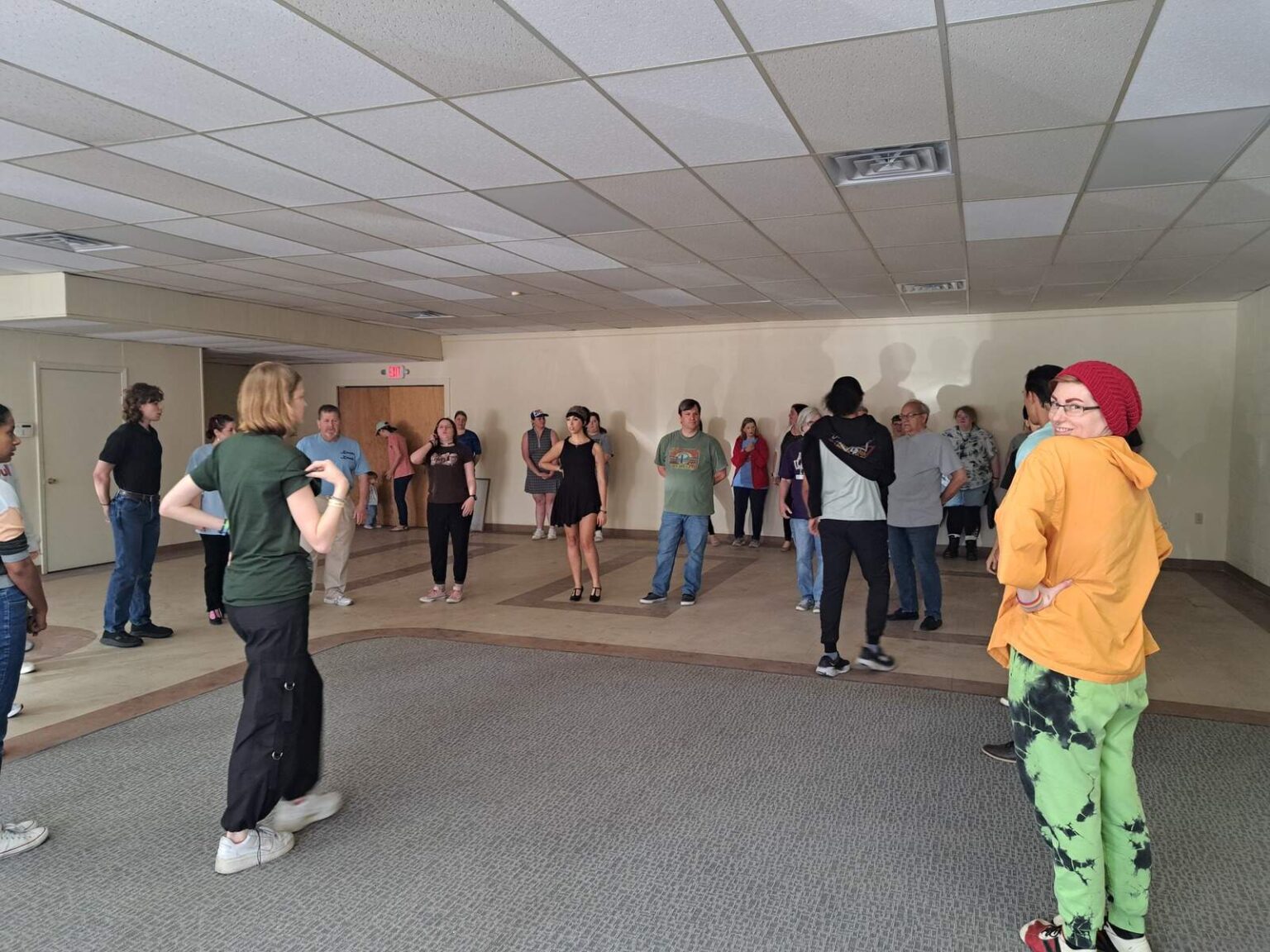 Performers listening to instruction while refining Gavotte choreography