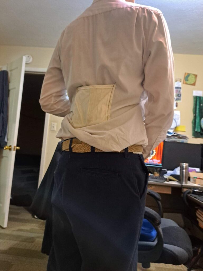 Shirt with cooling compartment on lower back shown from behind.