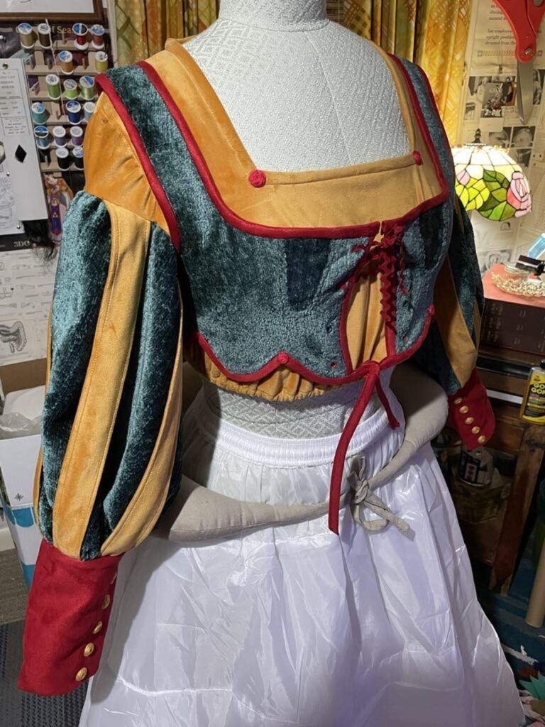 In-progress ball-room bodice in green, gold, and red with puffed sleeves