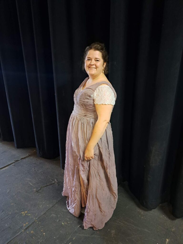 Full-length shot of Katie wearing an elegant lilac gown