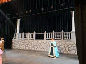 A gray faux-stone balcony platform with decorative railing on the Lyric stage