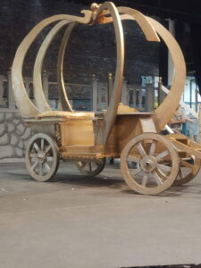 Side view of a gold, pumpkin-shaped carriage